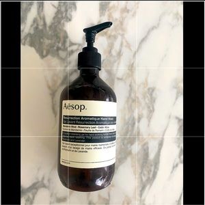 Empty Aesop hand soap bottle